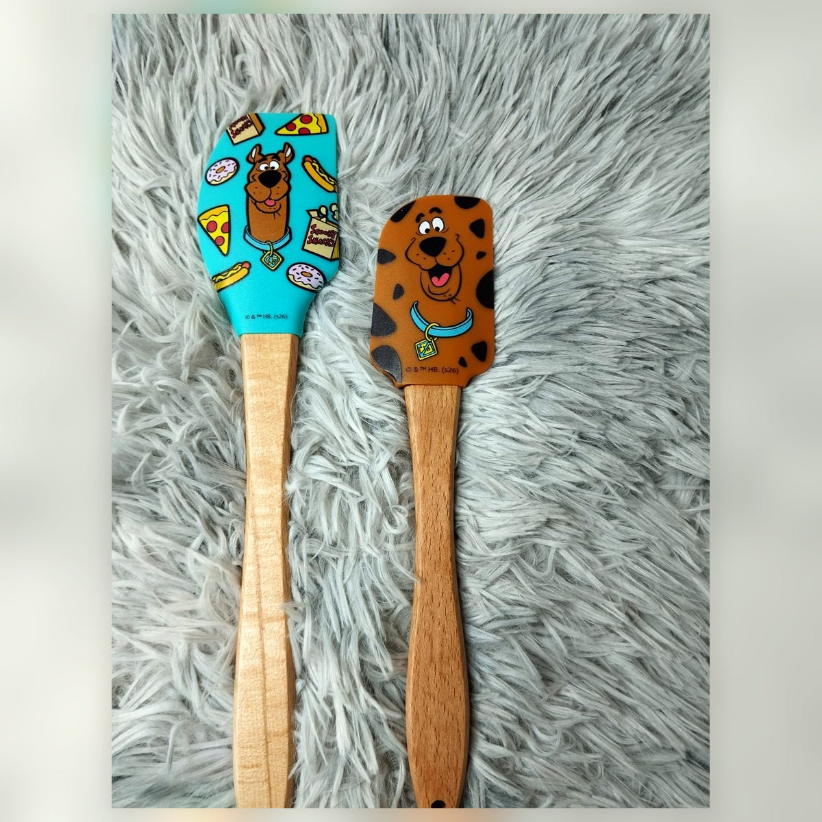 Scooby-Doo themed two-piece silicone spatula set with turquoise snack-print and brown character-face designs with wooden handles
